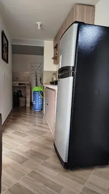 a kitchen with a black and white refrigerator at DESTINY Apto villas del Río in San Rafael