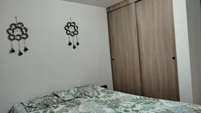 a bedroom with a bed and a wooden cabinet at DESTINY Apto villas del Río in San Rafael