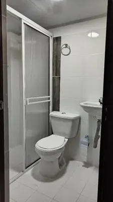a white bathroom with a toilet and a sink at DESTINY Apto villas del Río in San Rafael