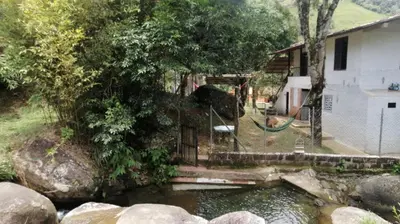 a pool of water next to a house at Refugio en el arroyo in San Carlos