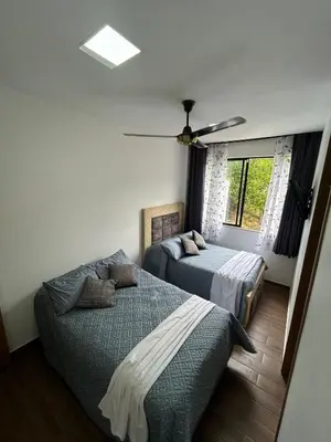 a bedroom with two beds and a ceiling fan at Villa Los Pinos in Sopetran