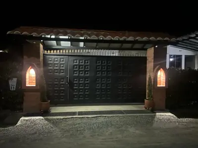 a house with a garage door at night at Villa Los Pinos in Sopetran