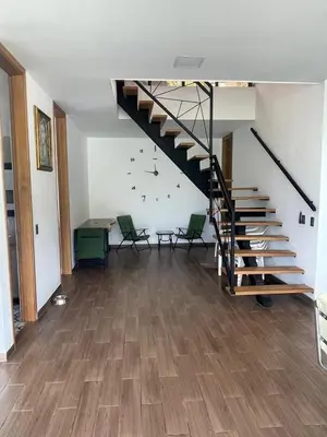 a living room with a staircase in a house at Villa Los Pinos in Sopetran