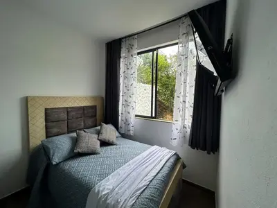 a bedroom with a bed and a window at Villa Los Pinos in Sopetran
