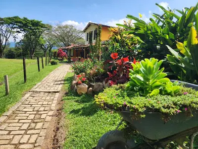 a garden with flowers and plants in front of a house at Finca la India Cerro Tusa in Tarso