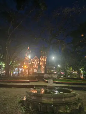 a fountain in front of a building at night at Finca la India Cerro Tusa in Tarso