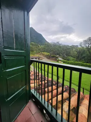 a balcony with a door and a view of a river at Finca la India Cerro Tusa in Tarso