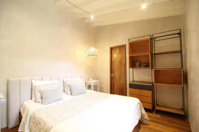 a bedroom with a large white bed with white pillows at Salina Casa de Huespedes in El Retiro