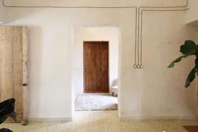 a hallway with a wooden door in a room at Salina Casa de Huespedes in El Retiro