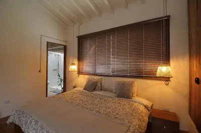 a bedroom with a bed with two pillows and a window at Salina Casa de Huespedes in El Retiro