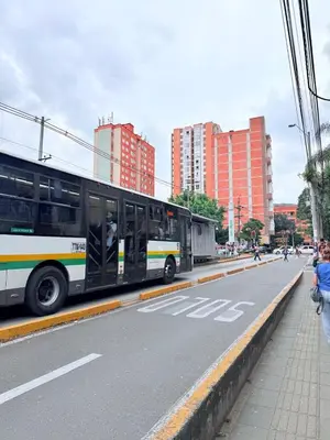 a bus is driving down a city street at Aparta estudio 103 - Casa bendita in Medellín