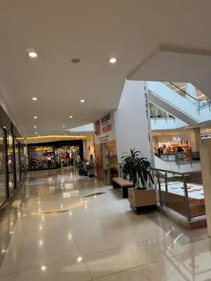 a lobby of a shopping mall with a potted plant at Aparta estudio 103 - Casa bendita in Medellín