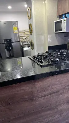 a kitchen counter with a stove and a microwave at El Poblado Apto cerca a Parque Lleras y Provenza in Medellín