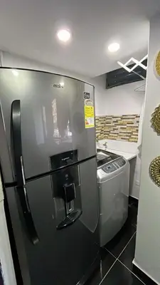 a kitchen with a refrigerator and a trash can at El Poblado Apto cerca a Parque Lleras y Provenza in Medellín