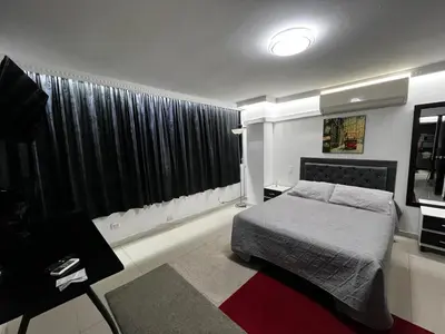 a bedroom with a bed and a large window at El Poblado Apto cerca a Parque Lleras y Provenza in Medellín