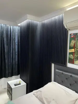 a bedroom with a bed and a black wall at El Poblado Apto cerca a Parque Lleras y Provenza in Medellín