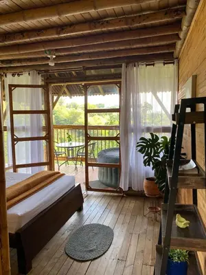 a bedroom with a bed and a window at Glamping Falan Tolima in Falan