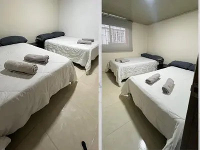 a bedroom with two beds with towels on them at Casa amoblada 15 personas 6 habitaciones 4 baños - Frente al terminal y cable aereo, Cerca de Expoferias, Bosque Popular y Termales del Otoño in Manizales