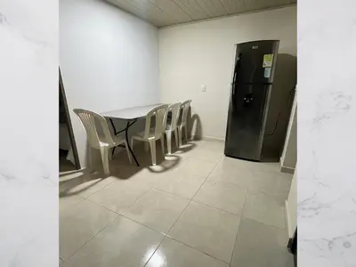 a room with a table and chairs and a refrigerator at Casa amoblada 15 personas 6 habitaciones 4 baños - Frente al terminal y cable aereo, Cerca de Expoferias, Bosque Popular y Termales del Otoño in Manizales