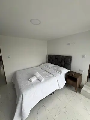 a bedroom with a bed with two towels on it at Alojamiento Privado en Avenida Principal in Manizales