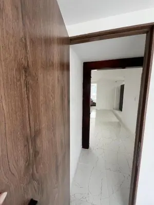 a room with a wooden door and a hallway at Alojamiento Privado en Avenida Principal in Manizales