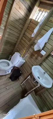 a bathroom with a toilet and a sink at Entre Colinas Lodge in El Peñol