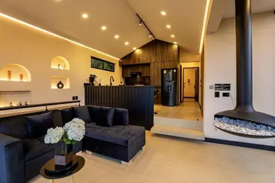 a living room with a couch and a stove at Villa Kobus in San Antonio de Pereira