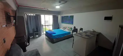 a room with a bed and a table in it at Medellín Apartment Loft in Medellín