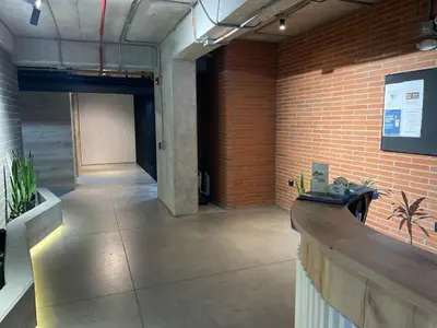 an empty room with a brick wall and a counter at Medellín Apartment Loft in Medellín