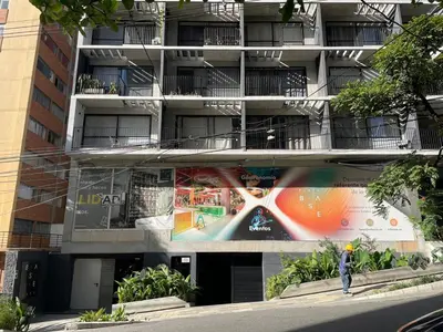 a person walking in front of an apartment building at Medellín Apartment Loft in Medellín