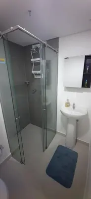 a bathroom with a glass shower and a sink at Medellín Apartment Loft in Medellín