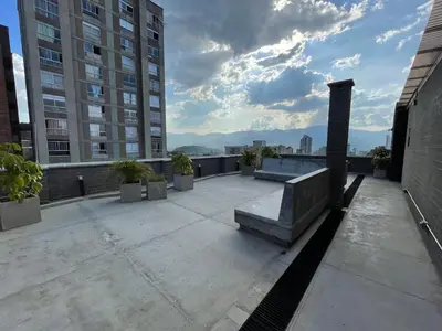 a balcony with a bench on top of a building at Medellín Apartment Loft in Medellín