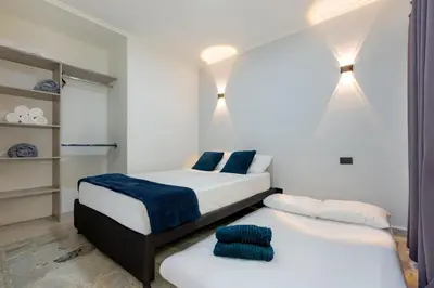 a bedroom with two beds with blue pillows at Great family home near the stadium and beautiful neighborhood in Medellín