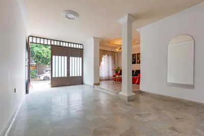 an empty hallway with a door and a living room at Great family home near the stadium and beautiful neighborhood in Medellín