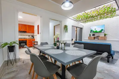 a dining room with a table and chairs at Great family home near the stadium and beautiful neighborhood in Medellín