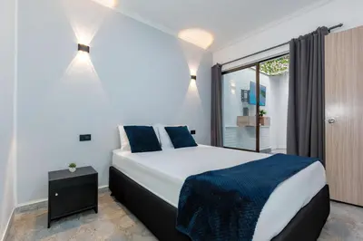 a bedroom with a large bed and a window at Great family home near the stadium and beautiful neighborhood in Medellín