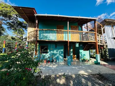 a house with a deck on the side of it at Titiribi-Antioquia- Cabaña el sol in Titiribí