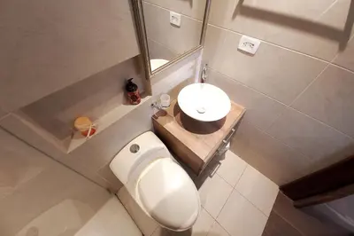a bathroom with a white toilet and a sink at Amazing view - Poblado in Medellín