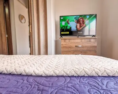 a bedroom with a bed and a tv on a dresser at Amazing view - Poblado in Medellín