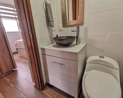 a bathroom with a sink and a toilet at Amazing view - Poblado in Medellín