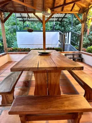 a wooden table in the middle of a patio at Casa Verano la rumbita Naturaleza, Piscina y Rio in Santa Fe de Antioquia