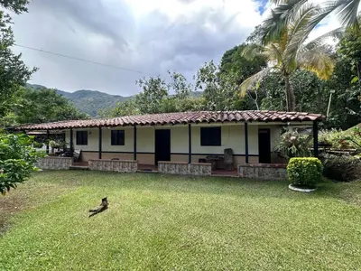 a small house with a bird in the yard at Casa Verano la rumbita Naturaleza, Piscina y Rio in Santa Fe de Antioquia