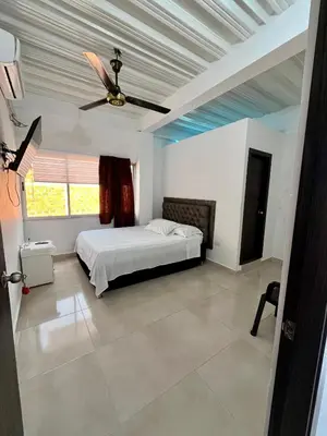 a bedroom with a bed and a ceiling fan at Habitación Central en Doradal 01 in Puerto Triunfo