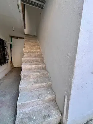 a stairway leading up to a building with a cement wall at Habitación Central en Doradal 01 in Puerto Triunfo