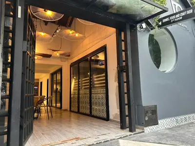 a front door of a restaurant with a table at Hotel 79 Poblado in Medellín