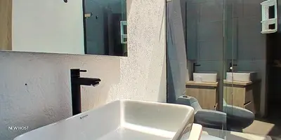 a bathroom with a sink and a toilet and a mirror at lujosa villa campestre in Girardota