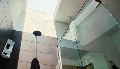 a glass wall in a room with a phone on the wall at lujosa villa campestre in Girardota
