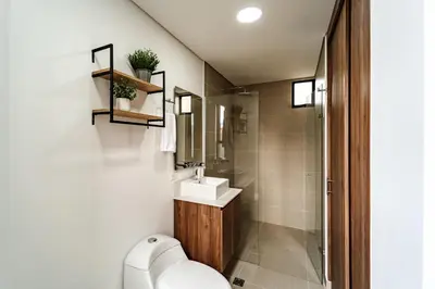 a bathroom with a toilet and a sink at MEDELLIN LAURELES POR DÁS in Medellín