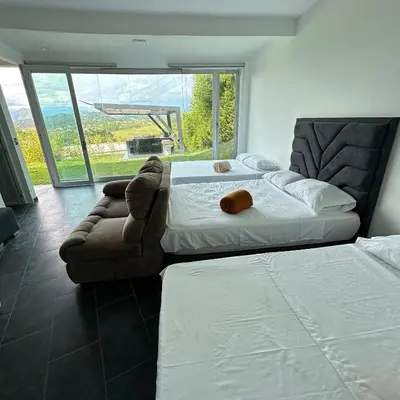a bedroom with a large bed and a couch at XDfinca in Palermo