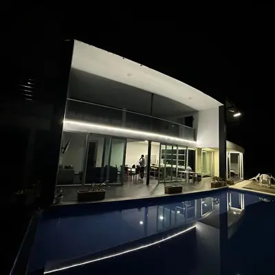a large house with a swimming pool at night at XDfinca in Palermo